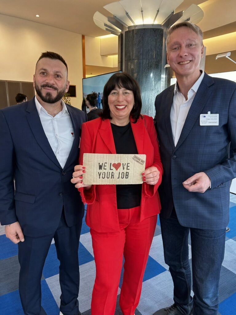 Holger Holland im Europäischen Parlament mit „We love your job“-Schild